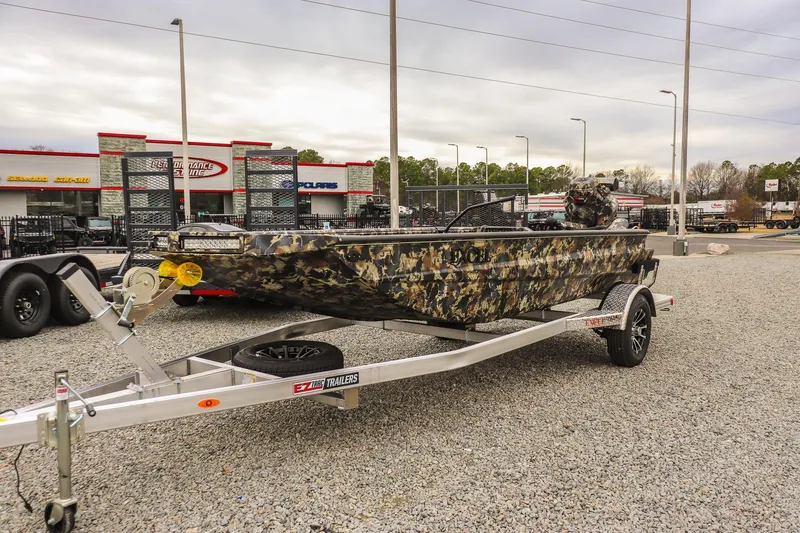 The Image of Camo-patterned 2026 Excel 1751 F4 boat on trailer at dealership lot. - 0