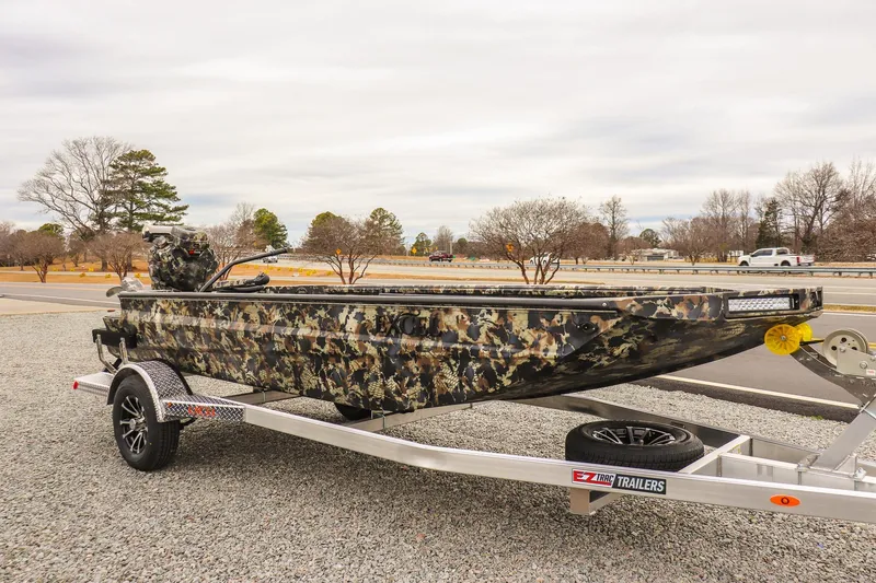 Slide: The Image of 2026 Excel 1751 F4 camouflage boat on trailer, parked outdoors. - 5