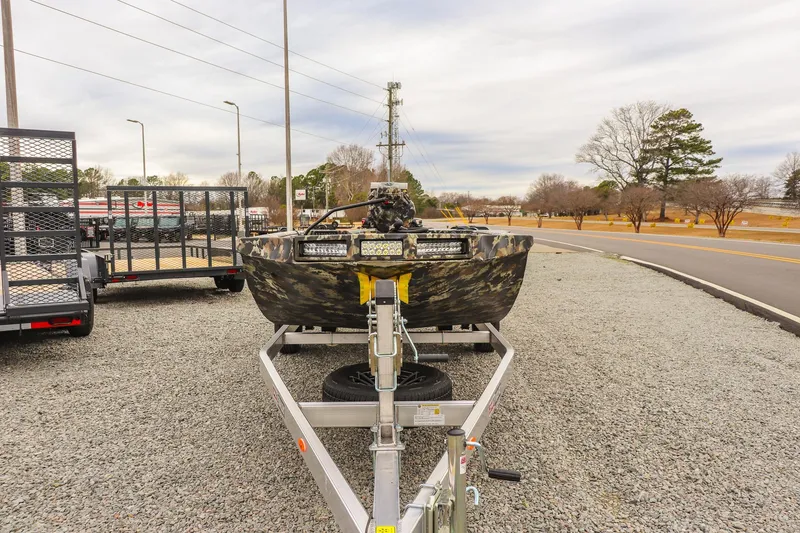 Slide: The Image of 2026 Excel 1751 F4 boat on trailer, parked on gravel near road. - 6
