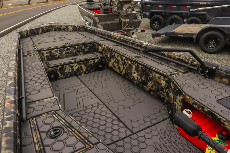 Slide: The Image of 2026 Excel 1751 F4 boat interior with camouflage design and hexagonal pattern flooring. - 9