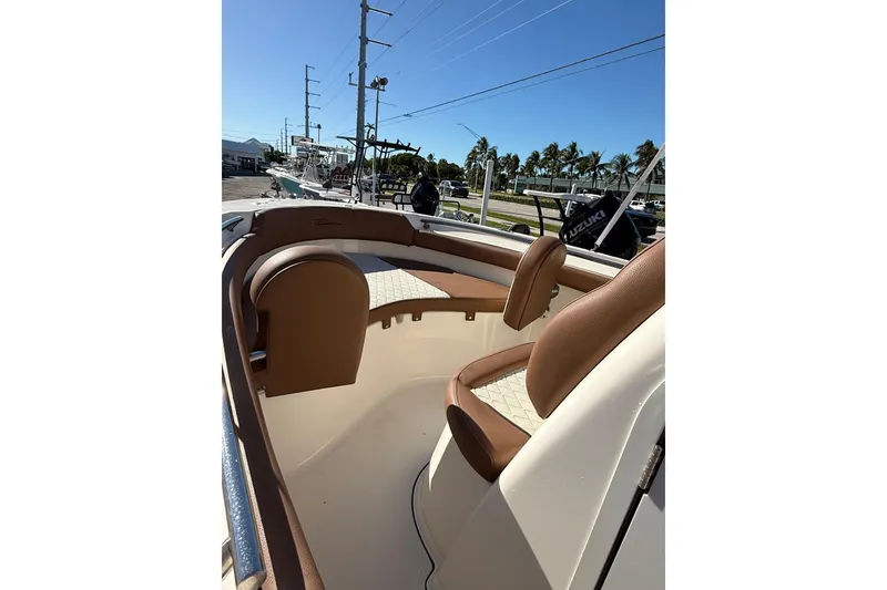 Slide: The Image of 2023 Pioneer 202 Islander boat interior with brown seating and open deck. - 10