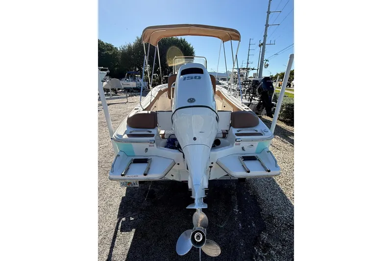 Slide: The Image of 2023 Pioneer 202 Islander boat with Yamaha 150 engine, rear view in outdoor setting. - 4