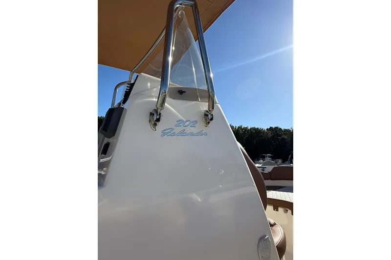 Slide: The Image of 2023 Pioneer 202 Islander boat, sleek design, sunny day, clear blue sky. - 5