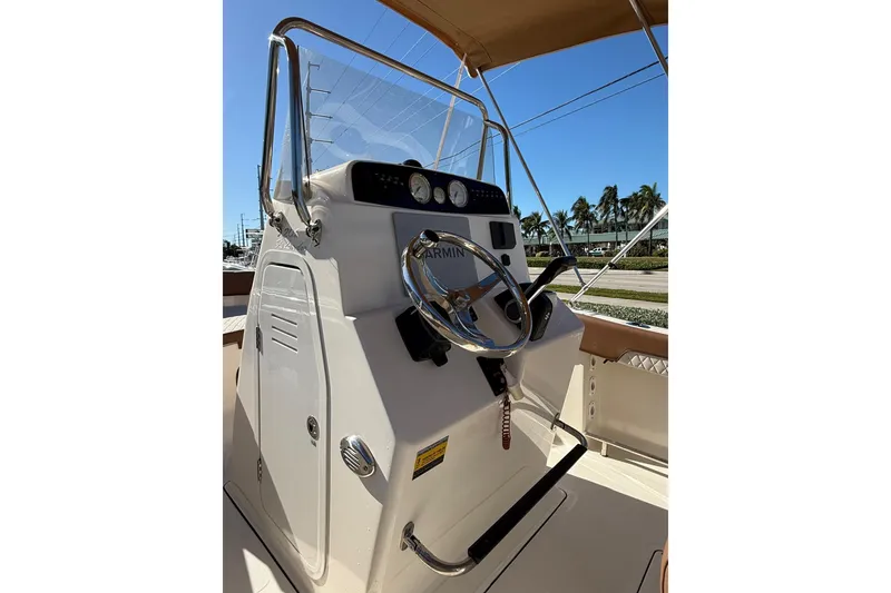 Slide: The Image of 2023 Pioneer 202 Islander boat console with steering wheel and navigation equipment. - 7