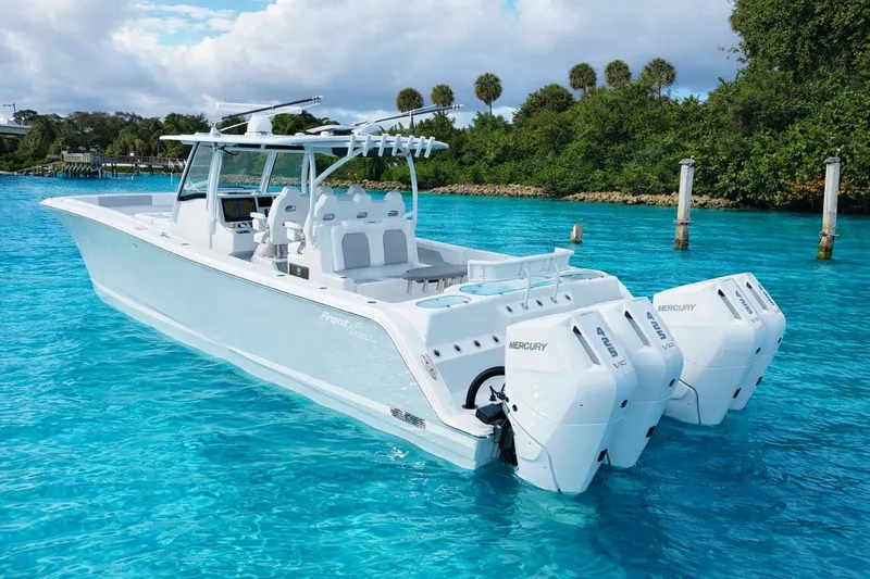 Slide: The Image of 2026 Front Runner 43 Catamaran on clear water with triple Mercury engines. - 1