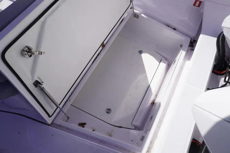 Slide: The Image of Open storage compartment on 2025 Axopar 29 Sun-Top boat. - 18