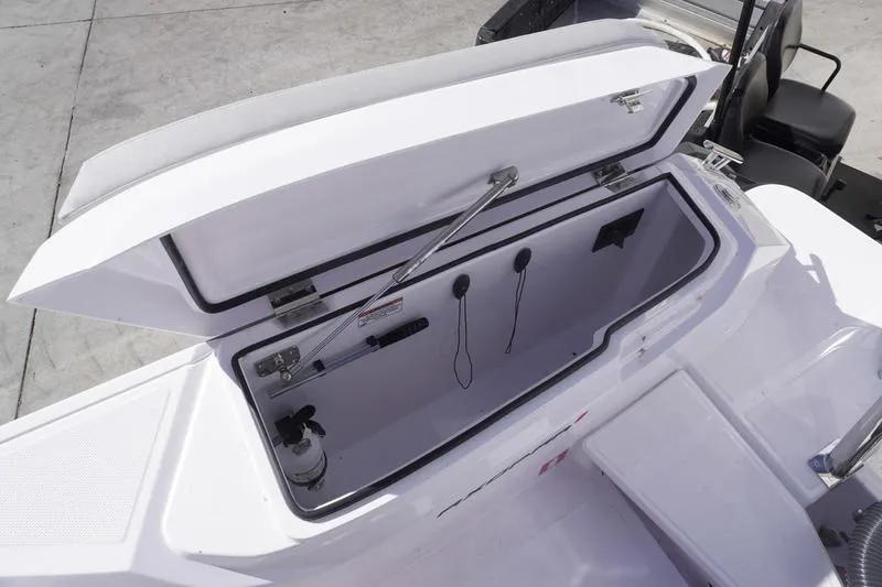 Slide: The Image of Open storage compartment on 2025 Axopar 29 Sun-Top boat, featuring modern design and functionality. - 23