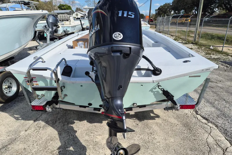 Slide: The Image of 2026 Xpress H20B Bay boat with Yamaha 115 outboard motor, rear view. - 16