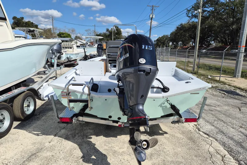 Slide: The Image of 2026 Xpress H20B Bay boat with Yamaha 115 engine on trailer, outdoor display. - 2