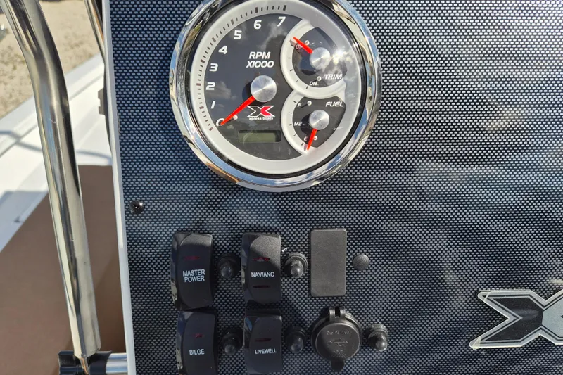Slide: The Image of Control panel of 2026 Xpress H20B Bay boat with gauges and switches. - 8