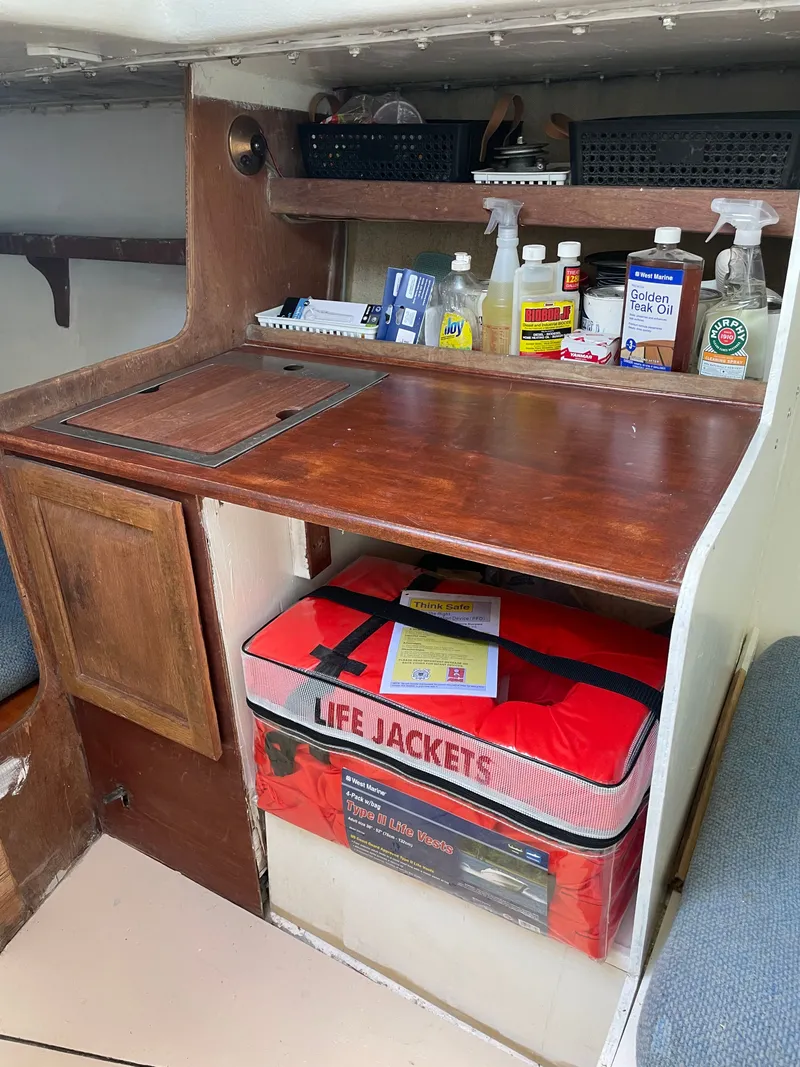 Slide: The Image of Interior of a J/35 yacht with safety gear and cleaning supplies. - 17