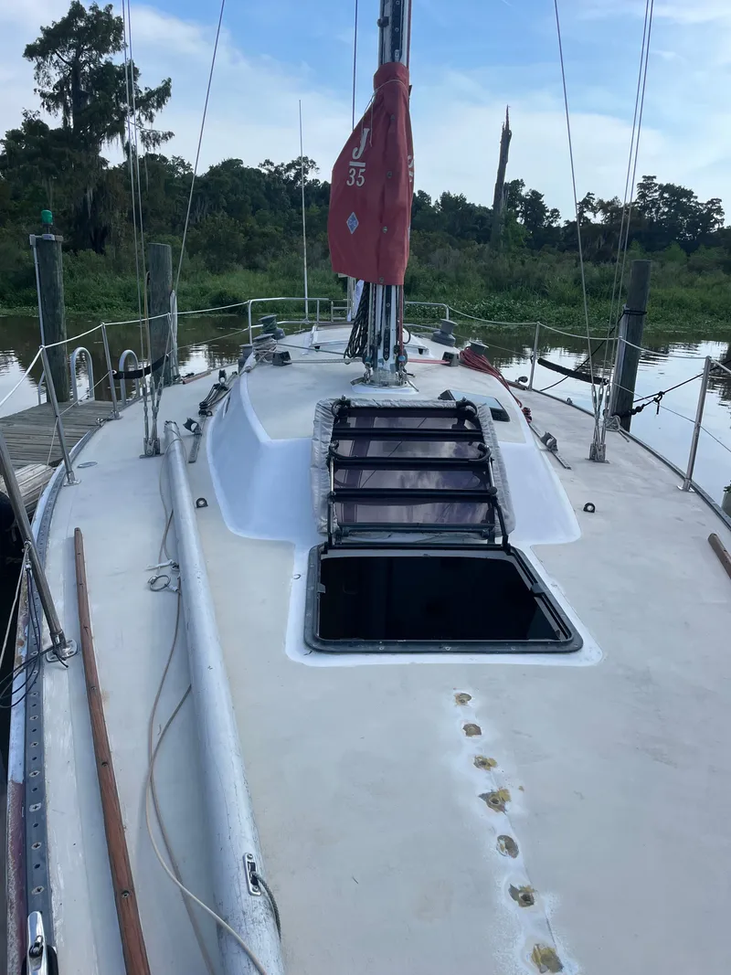 Slide: The Image of 1983 J/35 sailboat deck view with red sail. - 2