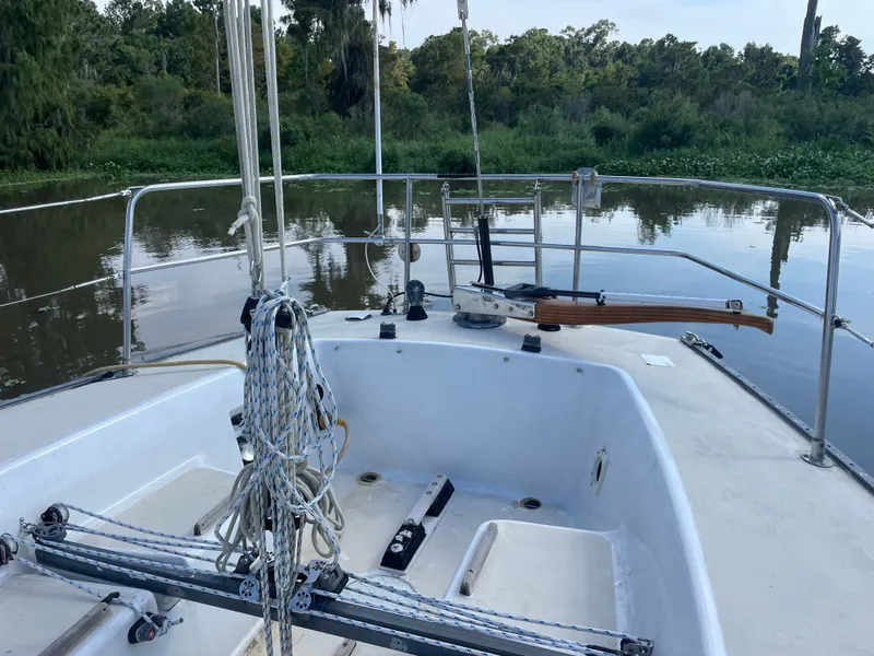 Slide: The Image of 1983 J Boats J/35 sailboat cockpit on calm river. - 6