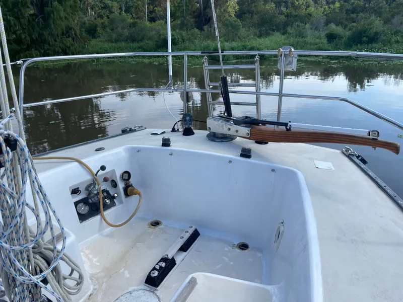 Slide: The Image of 1983 J Boats J/35 sailboat cockpit by a river. - 7