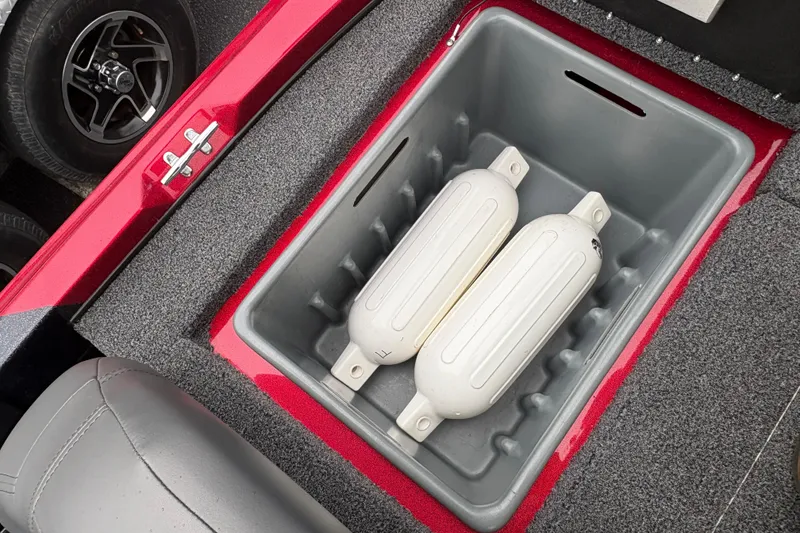 Slide: The Image of Storage compartment in a 2025 Nitro Z17 boat with two white fenders inside. - 11