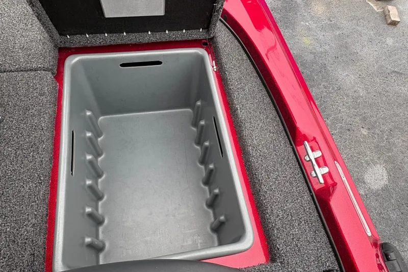 Slide: The Image of Red Nitro Z17 2025 boat storage compartment with gray interior and carpeted edges. - 12