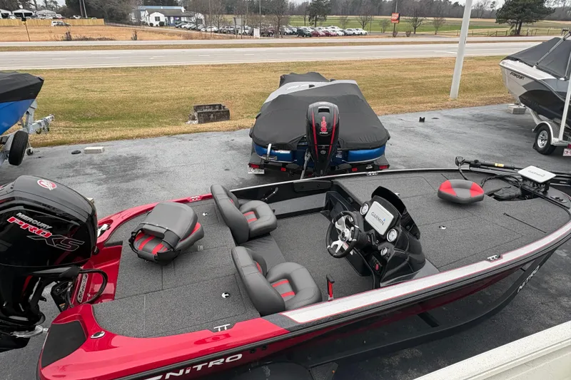 Slide: The Image of 2025 Nitro Z17 boat with Mercury Pro XS engine, parked outdoors on a paved surface. - 3