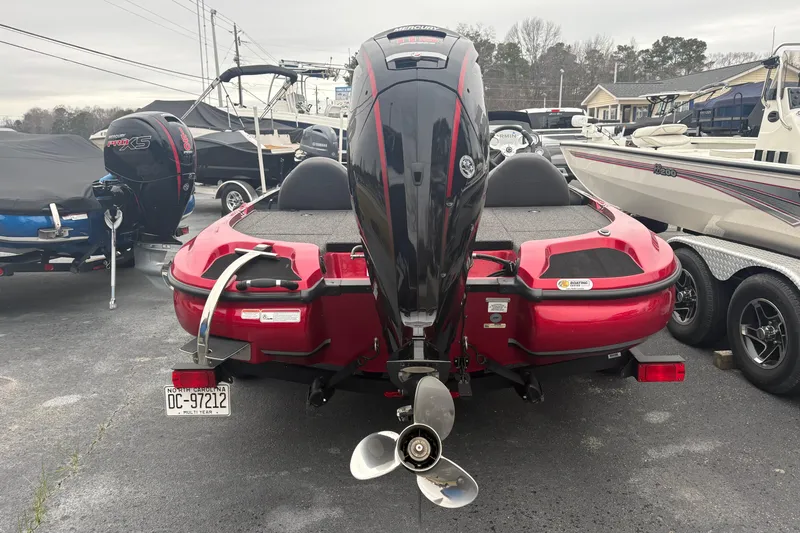 Slide: The Image of Red 2025 Nitro Z17 boat with Mercury engine, parked in a lot. - 5