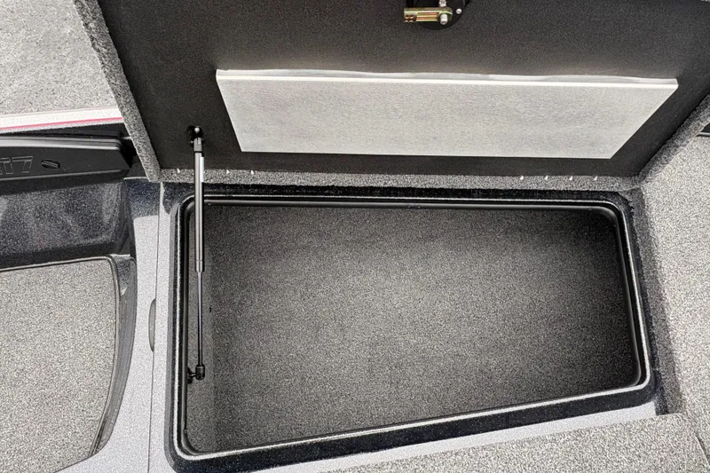 Slide: The Image of Open storage compartment in 2025 Nitro Z17 boat, featuring carpeted interior and hydraulic lift. - 8