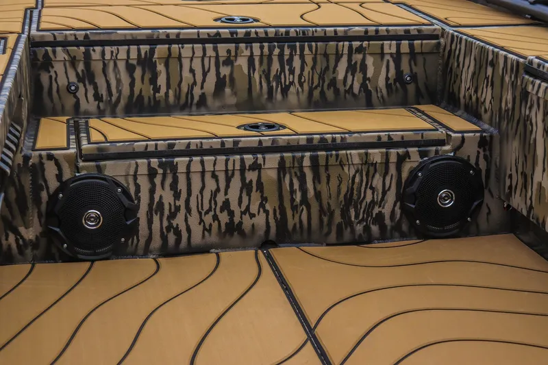 Slide: The Image of 2026 Excel 1754 Shallow Water F4 boat interior with camo design and speakers. - 10