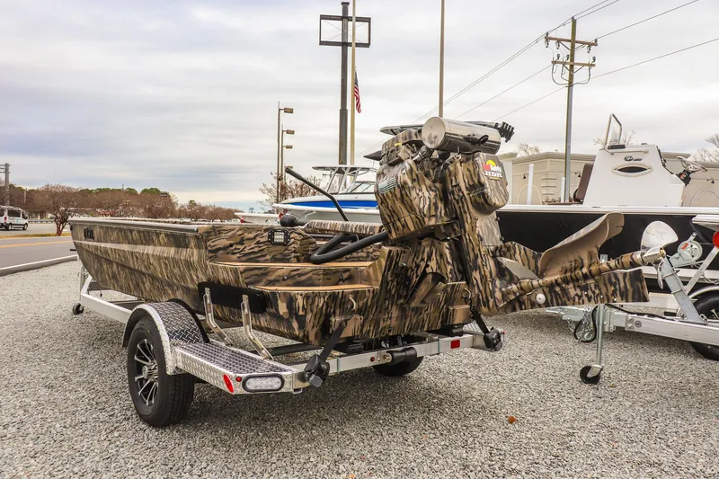 Slide: The Image of 2026 Excel 1754 Shallow Water F4 boat with camouflage design on a trailer. - 2
