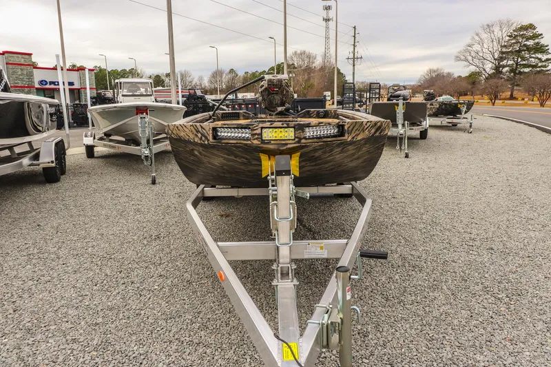 Slide: The Image of 2026 Excel 1754 Shallow Water F4 boat on trailer in outdoor dealership lot. - 6