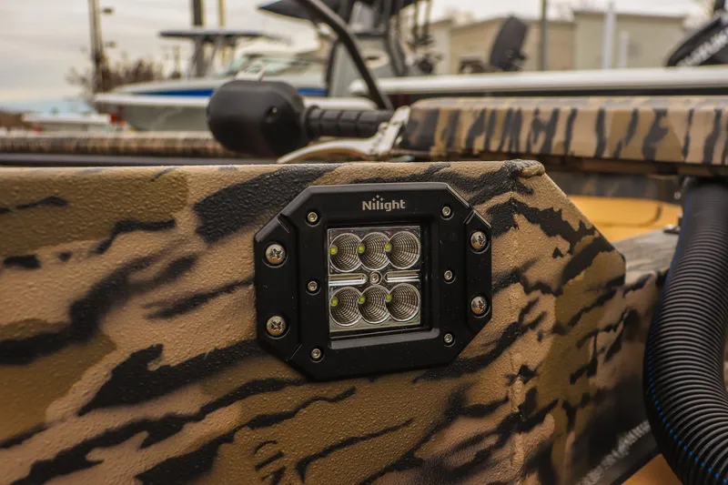 Slide: The Image of 2026 Excel 1754 Shallow Water F4 boat with camo design and mounted LED light. - 8