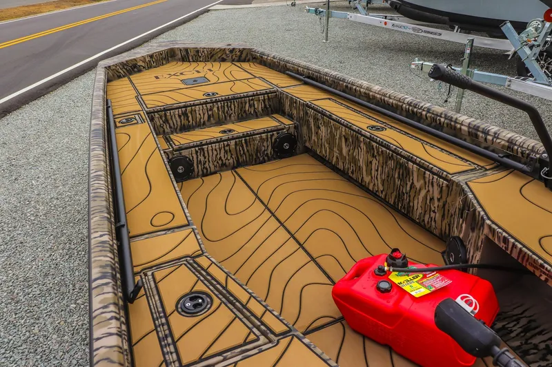 Slide: The Image of 2026 Excel 1754 Shallow Water F4 boat interior with camouflage design and red fuel tank. - 9