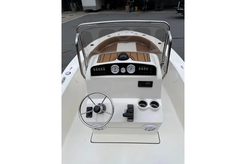 Slide: The Image of 2026 Pioneer 180 Islander boat console with steering wheel and gauges. - 3