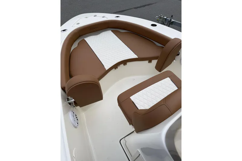 Slide: The Image of 2026 Pioneer 180 Islander boat interior with brown and white cushioned seating. - 5