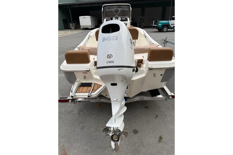 Slide: The Image of 2026 Pioneer 180 Islander boat with Suzuki outboard motor on trailer. - 7