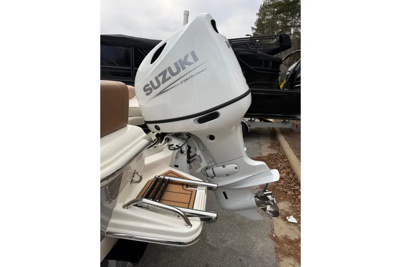 Slide: The Image of 2026 Pioneer 180 Islander boat with Suzuki outboard motor and swim ladder. - 8