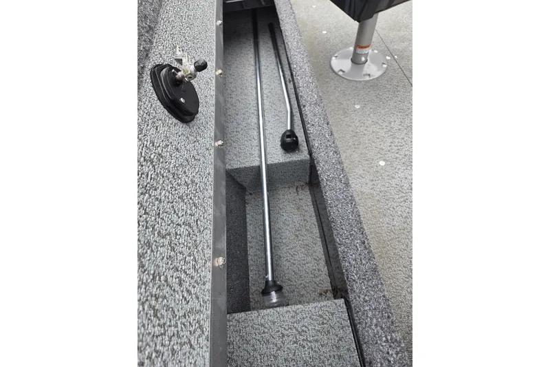 Slide: The Image of 2023 Lund 1650 Rebel XL Sport boat interior storage compartment with rod holders. - 12