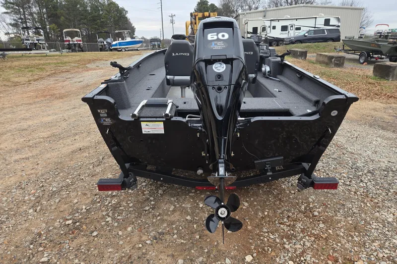 Slide: The Image of 2023 Lund 1650 Rebel XL Sport boat with 60 HP motor, parked on gravel lot. - 5