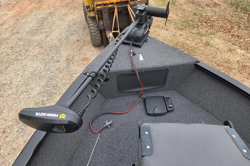 Slide: The Image of 2023 Lund 1650 Rebel XL Sport boat with Minn Kota trolling motor on deck. - 9