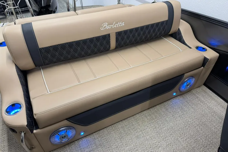 Slide: The Image of Luxurious Barletta Lusso 23UCA 2026 boat seating with elegant beige upholstery and blue LED lighting. - 12