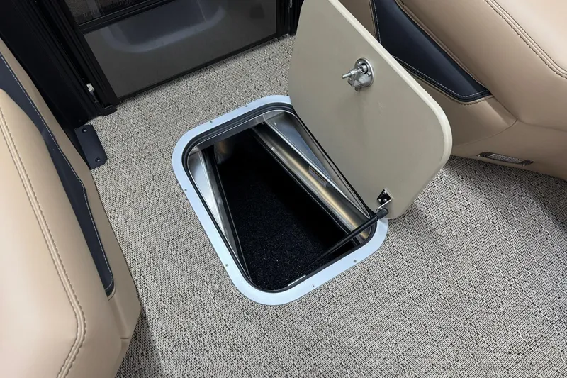 Slide: The Image of 2026 Barletta Lusso 23UCA boat interior storage compartment with beige seating and carpeted floor. - 32