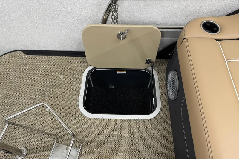 Slide: The Image of 2026 Barletta Lusso 23UCA boat interior with open storage compartment and beige seating. - 36