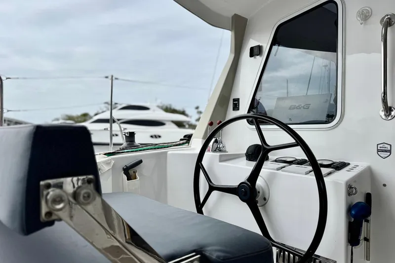 Slide: The Image of 2023 Seawind 1170 yacht cockpit with steering wheel and navigation controls. - 13