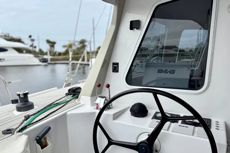 Slide: The Image of 2023 Seawind 1170 yacht cockpit with steering wheel and navigation equipment. - 14