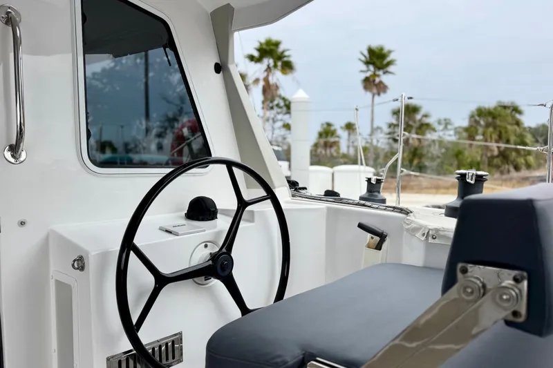 Slide: The Image of 2023 Seawind 1170 cockpit with steering wheel and outdoor view. - 15