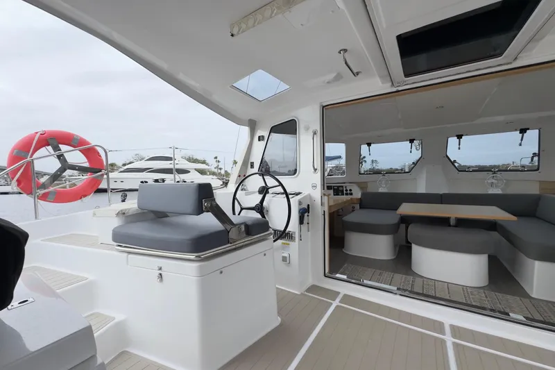 Slide: The Image of 2023 Seawind 1170 yacht interior with helm, seating, and dining area. - 18