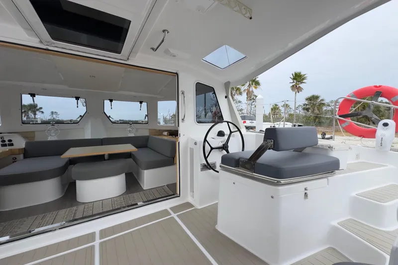 Slide: The Image of 2023 Seawind 1170 yacht interior with modern seating and steering area. - 19