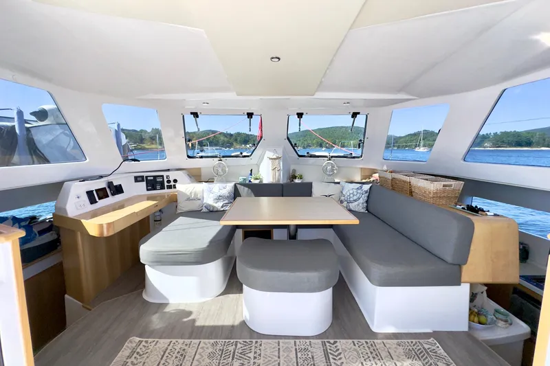 Slide: The Image of Interior of 2023 Seawind 1170 catamaran with modern seating and panoramic windows. - 21