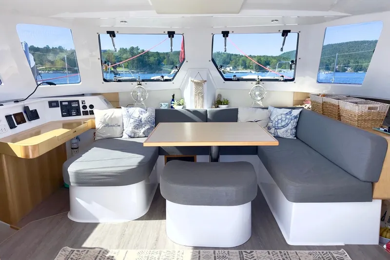 Slide: The Image of 2023 Seawind 1170 catamaran interior with modern seating and scenic windows. - 22