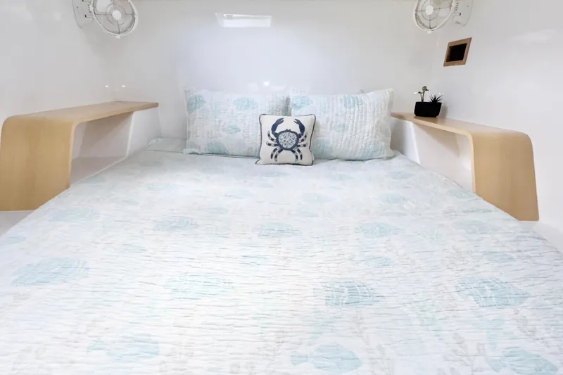 Slide: The Image of Cozy bedroom interior of 2023 Seawind 1170 yacht with nautical-themed bedding. - 24