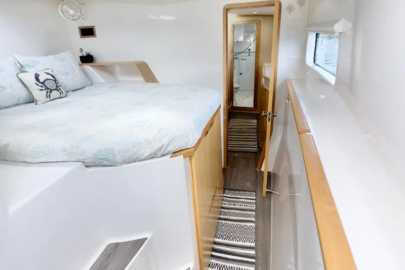Slide: The Image of 2023 Seawind 1170 yacht interior with cozy bedroom and modern bathroom. - 25