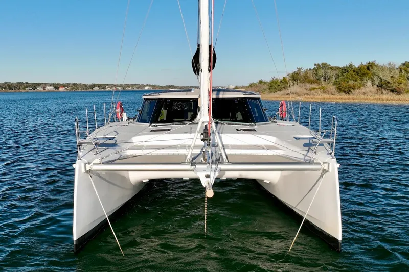 Slide: The Image of 2023 Seawind 1170 catamaran sailing on calm waters under clear blue sky. - 3