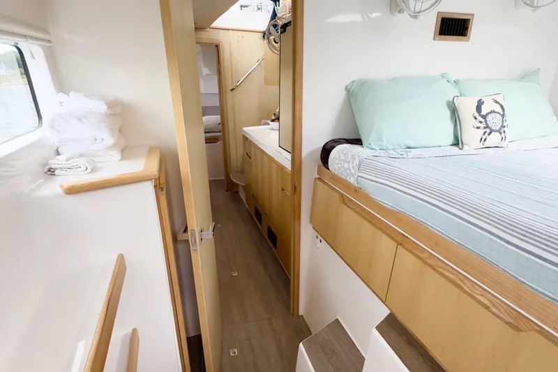 Slide: The Image of Interior of 2023 Seawind 1170 catamaran with cozy bedroom and modern bathroom. - 32