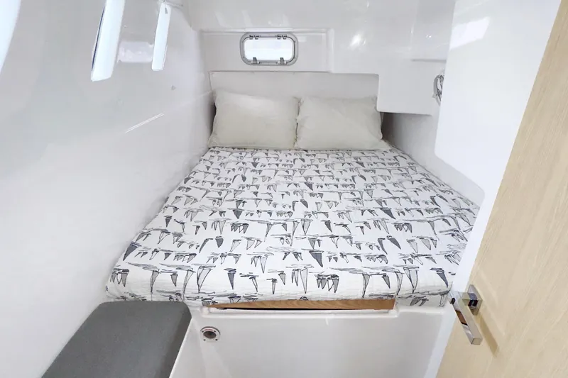 Slide: The Image of Cozy cabin interior of 2023 Seawind 1170 with patterned bedding and pillows. - 34